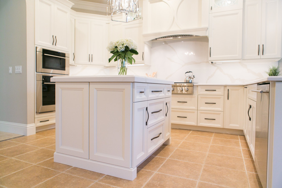 Example of a mid-sized transitional u-shaped open concept kitchen design in Orlando with an undermount sink, recessed-panel cabinets, white cabinets, quartzite countertops, white backsplash, stone slab backsplash, stainless steel appliances and a peninsula