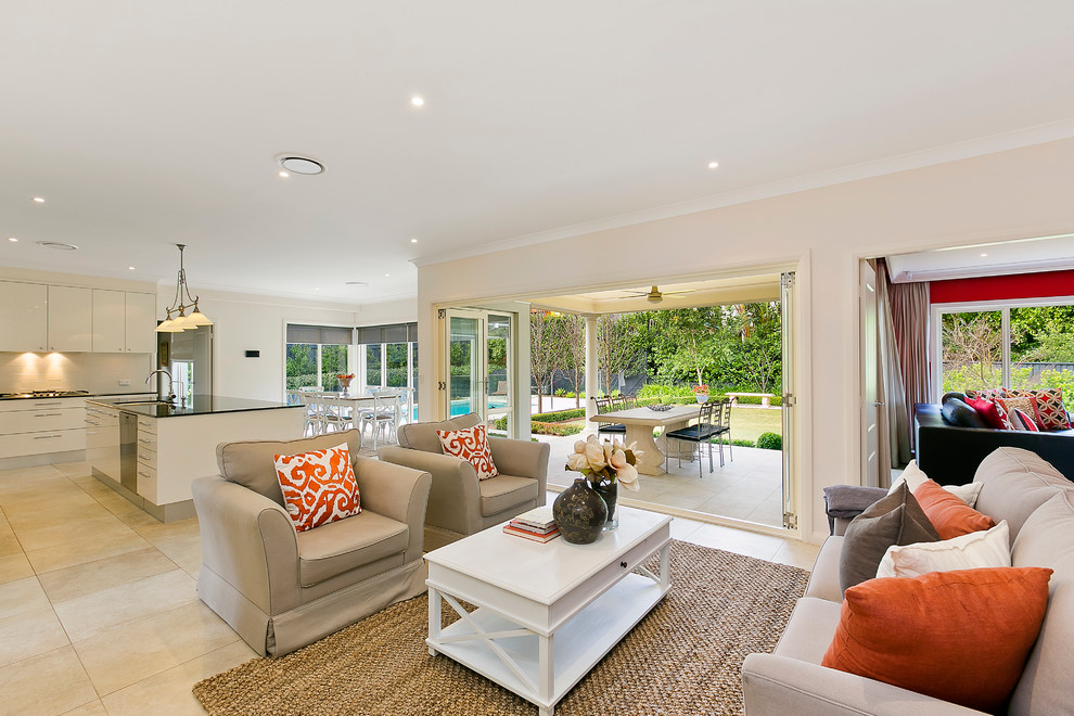 Large transitional open concept living room in Sydney with beige walls and travertine floors.
