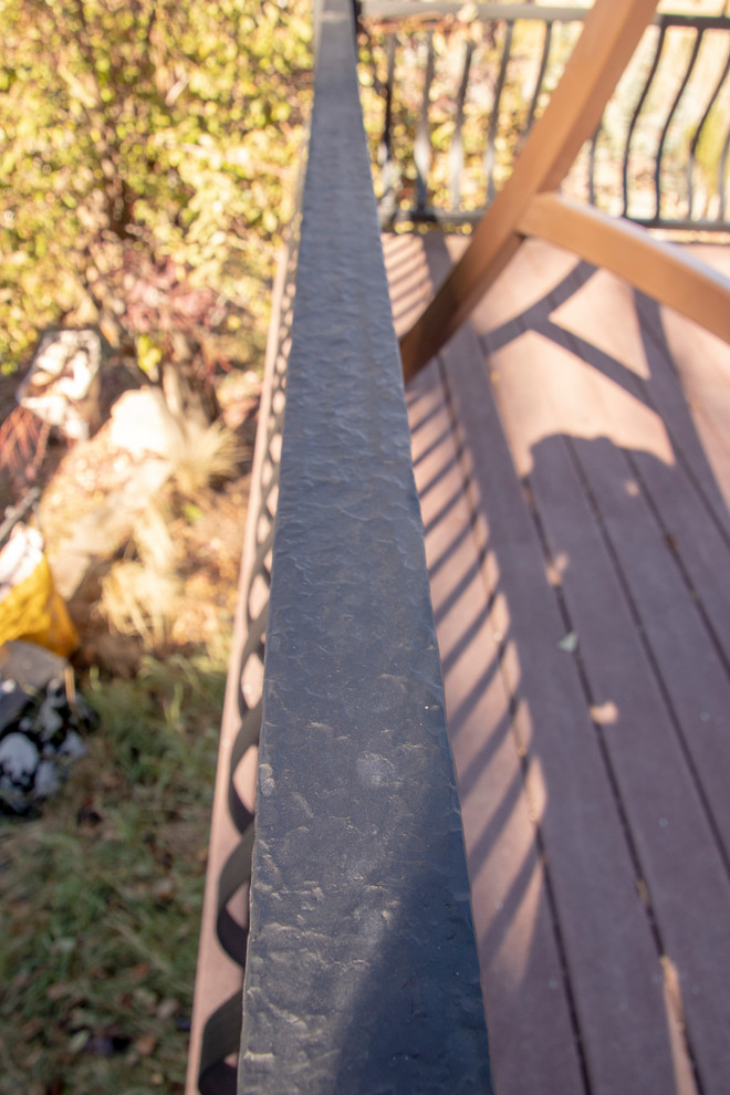 Example of a large mountain style backyard deck design with no cover