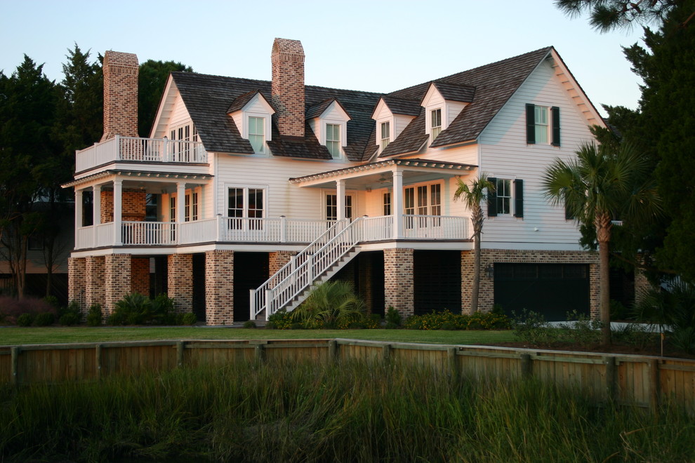 This is an example of a beach style exterior in Charleston with wood siding.