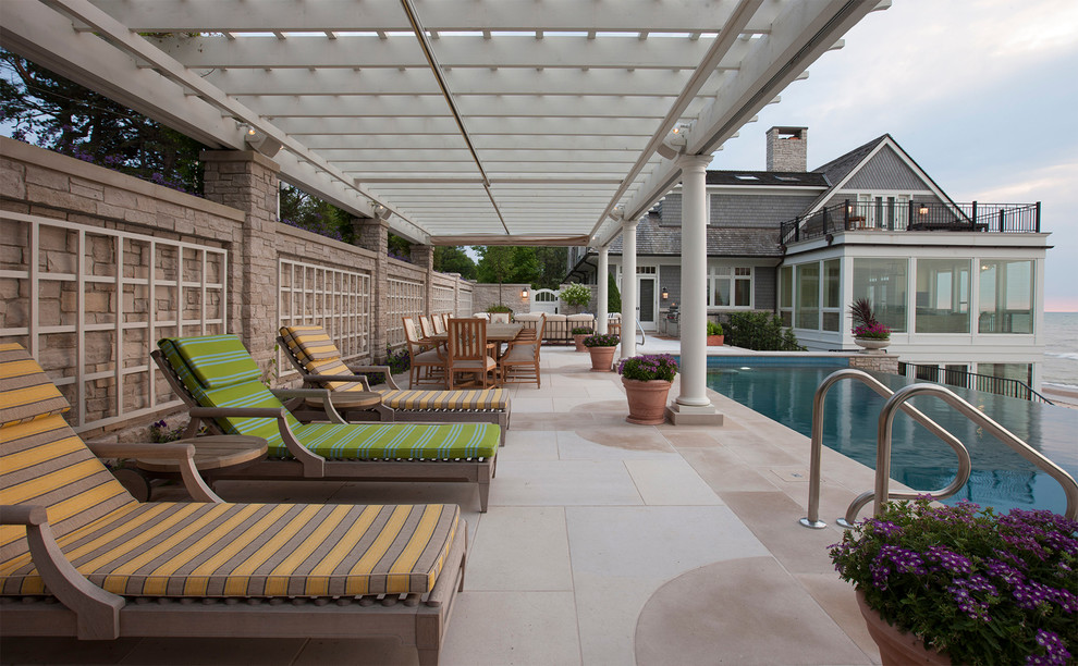 Photo of a large beach style pool in Chicago with concrete pavers.