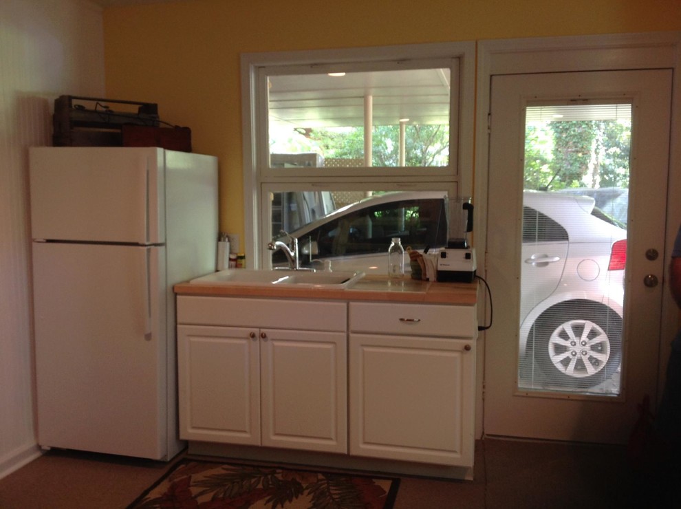 Example of a transitional look-out light wood floor basement design with yellow walls