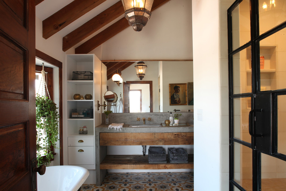 Mid-sized arts and crafts master bathroom in Los Angeles with open cabinets, light wood cabinets, a claw-foot tub, an alcove shower, white tile, cement tile and concrete benchtops.