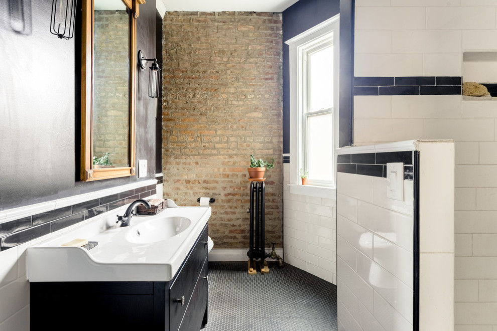 Industrial bathroom in Chicago with flat-panel cabinets, black cabinets, a corner shower, white tile, black walls, mosaic tile floors, a console sink, black floor and an open shower.