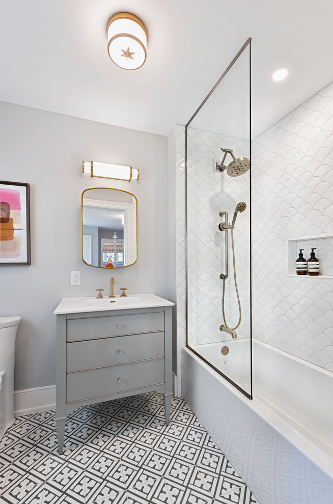 Inspiration for a large transitional kids bathroom in Ottawa with white tile, ceramic tile, grey walls, porcelain floors, multi-coloured floor, white benchtops, grey cabinets, a shower/bathtub combo, an integrated sink and flat-panel cabinets.