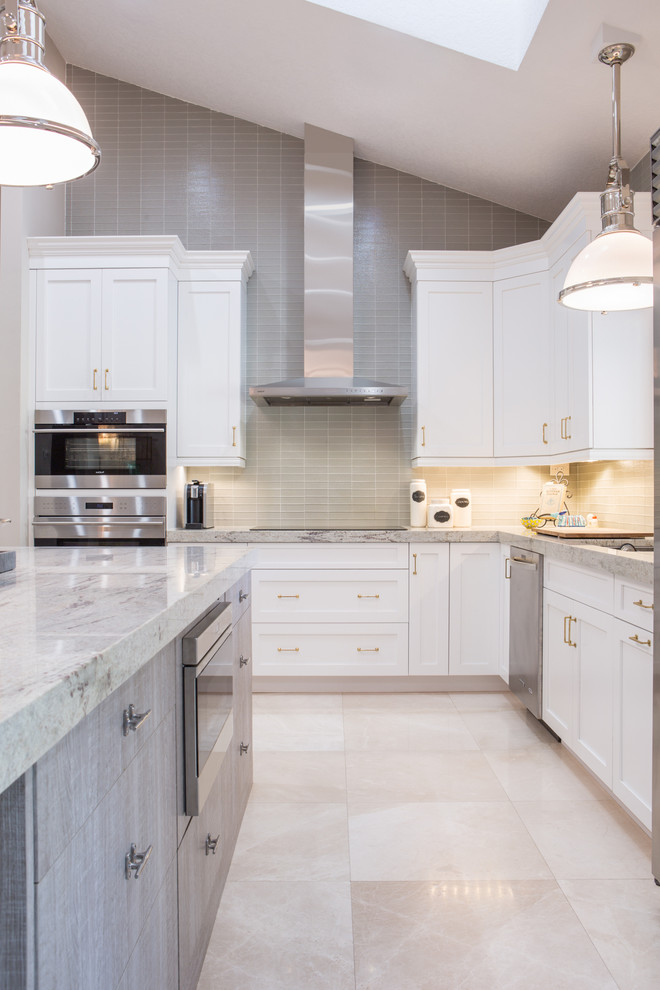Inspiration for a transitional l-shaped kitchen in Miami with shaker cabinets, white cabinets, grey splashback, matchstick tile splashback, stainless steel appliances and with island.
