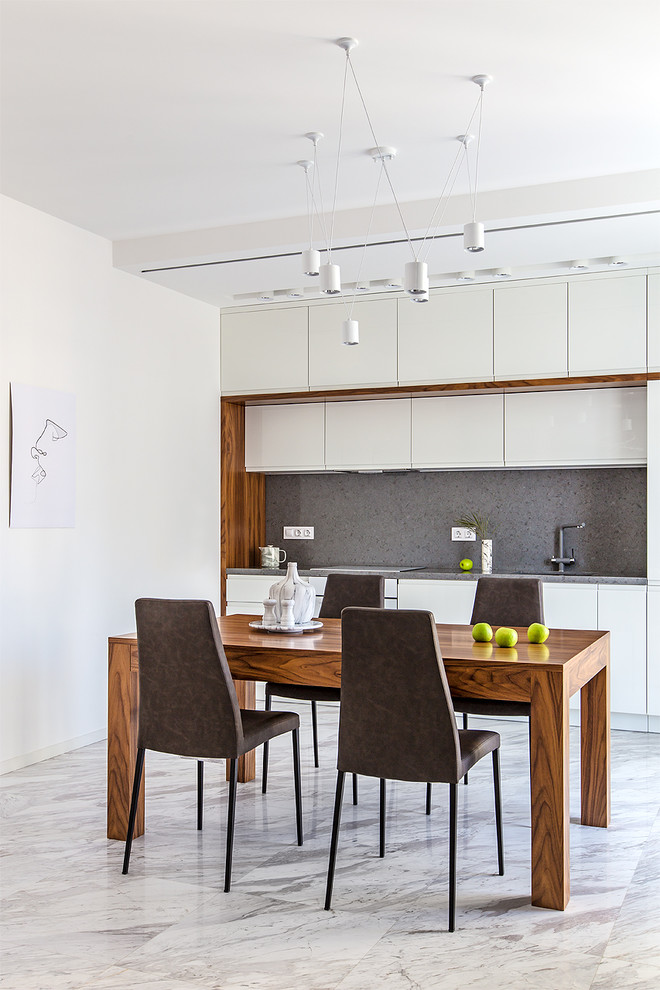 Contemporary single-wall eat-in kitchen in Moscow with flat-panel cabinets, white cabinets, grey splashback, marble floors, no island, white floor and grey benchtop.