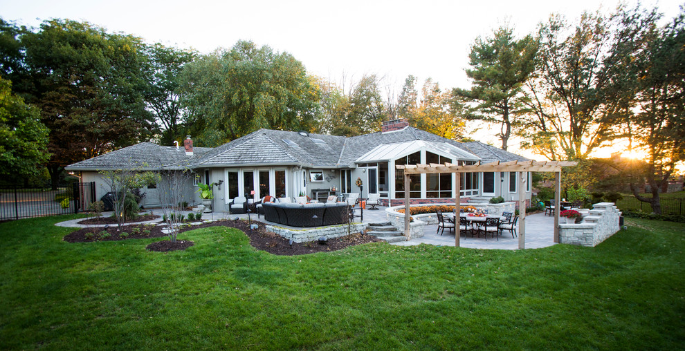 This is an example of a transitional backyard stone water fountain landscape in Omaha.