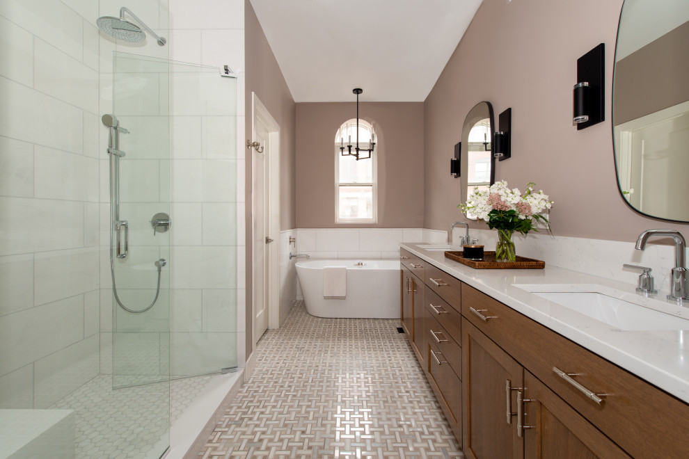 Transitional bathroom with shaker cabinets, medium wood cabinets, a freestanding tub, white tile, brown walls, mosaic tile floors, an undermount sink, beige floor, white benchtops, a shower seat, an enclosed toilet, a double vanity and a built-in vanity.