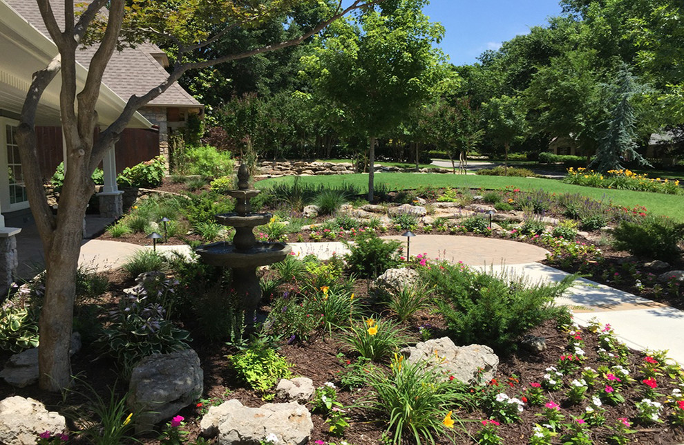 Photo of a large transitional full sun front yard brick formal garden for summer.