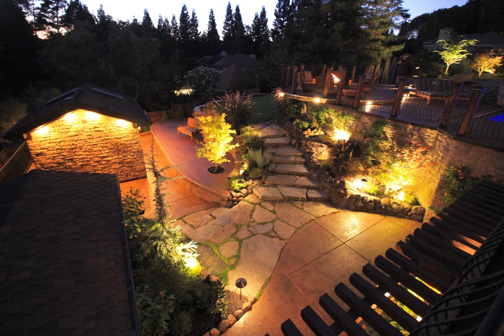 This is an example of a mid-sized country backyard full sun garden for summer in San Francisco with a garden path and natural stone pavers.