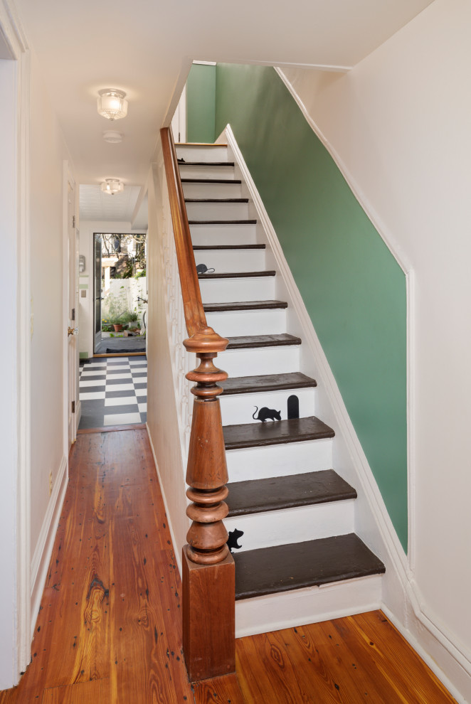 Photo of a medium sized victorian staircase in New York with wainscoting.