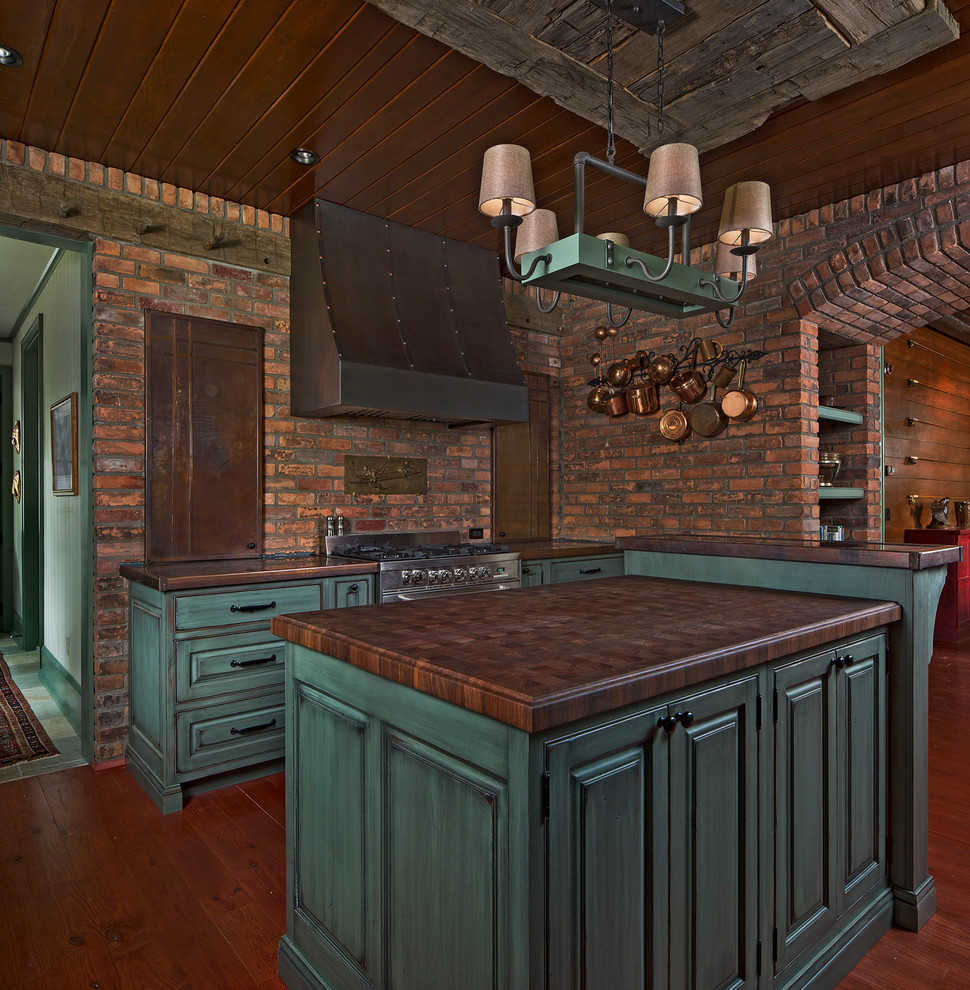 Photo of a country u-shaped kitchen in Detroit with a farmhouse sink, green cabinets, medium hardwood floors, with island and wood benchtops.