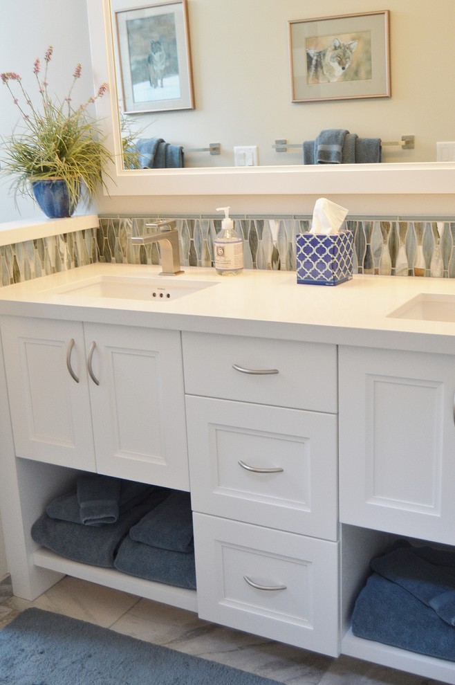 This is an example of a mid-sized transitional 3/4 bathroom in San Francisco with recessed-panel cabinets, white cabinets, an open shower, a one-piece toilet, white tile, stone tile, beige walls, marble floors, an undermount sink and marble benchtops.