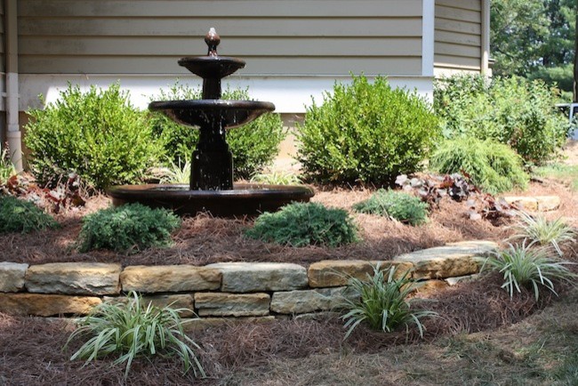 Inspiration for a transitional backyard garden in Cincinnati with a water feature and natural stone pavers.