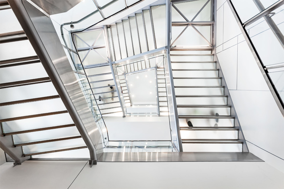 Large modern glass straight staircase in Vancouver with glass risers.