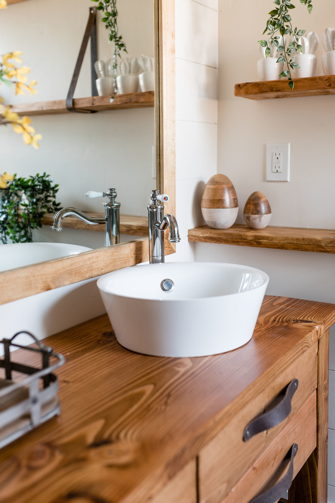 Design ideas for a small country master bathroom in Phoenix with furniture-like cabinets, medium wood cabinets, a corner shower, a one-piece toilet, white tile, mirror tile, white walls, mosaic tile floors, a vessel sink, wood benchtops and a hinged shower door.