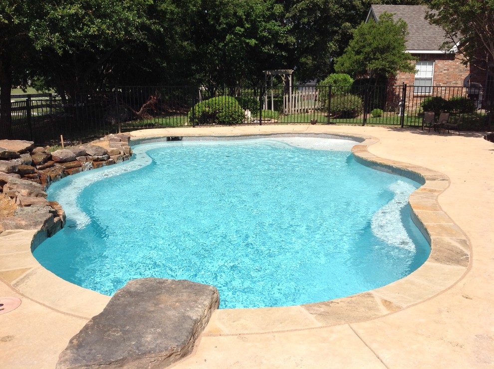 Mid-sized transitional backyard custom-shaped pool fountain photo in Dallas