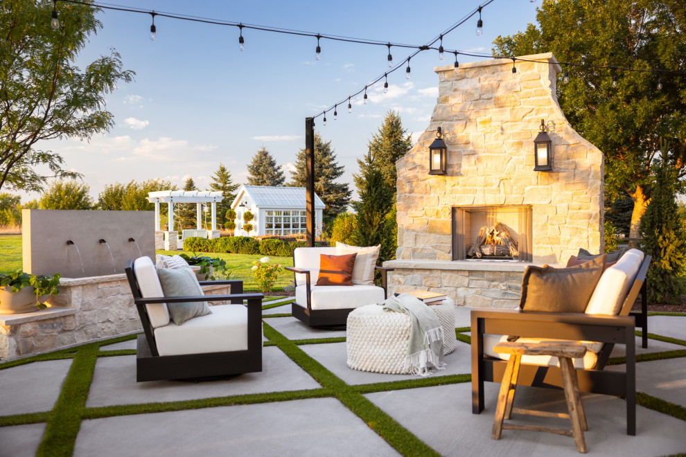 Patio - coastal concrete patio idea in Denver with a fireplace and no cover
