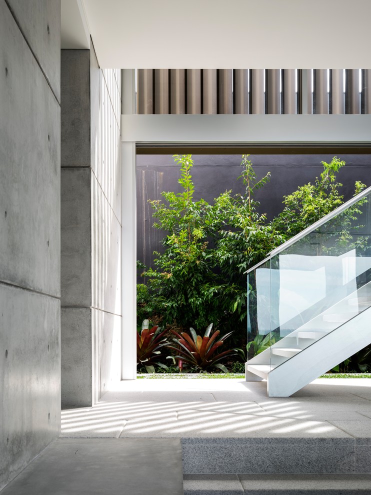 Design ideas for a contemporary staircase in Sydney with open risers and glass railing.