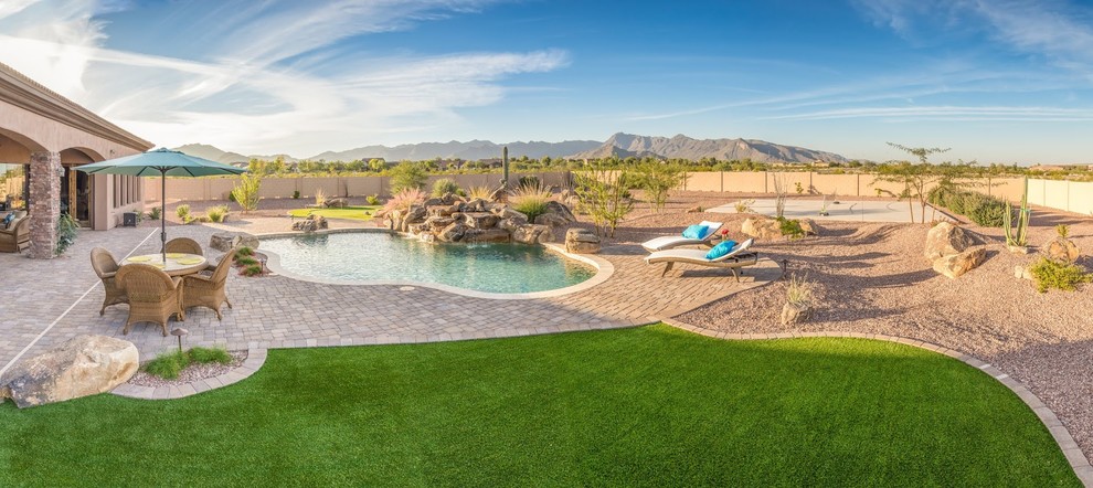 Photo of a large full sun backyard gravel outdoor basketball/tennis/multi-game court in Phoenix for summer.