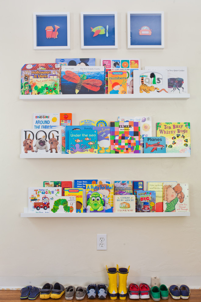 This is an example of a mid-sized traditional gender-neutral kids' room in Other with medium hardwood floors.