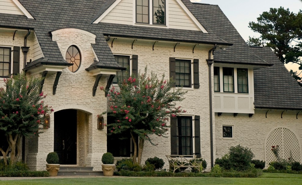 Photo of a mid-sized traditional three-storey brick beige house exterior in Atlanta with a shingle roof.