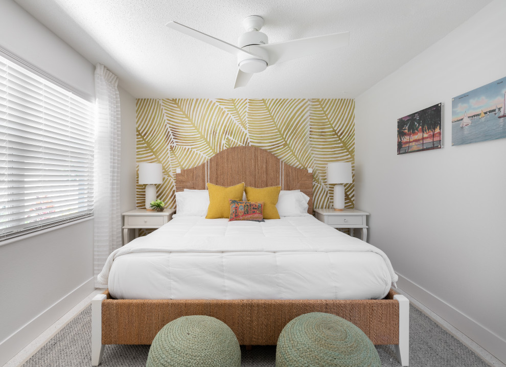 Photo of a small beach style master bedroom in Tampa with white walls.