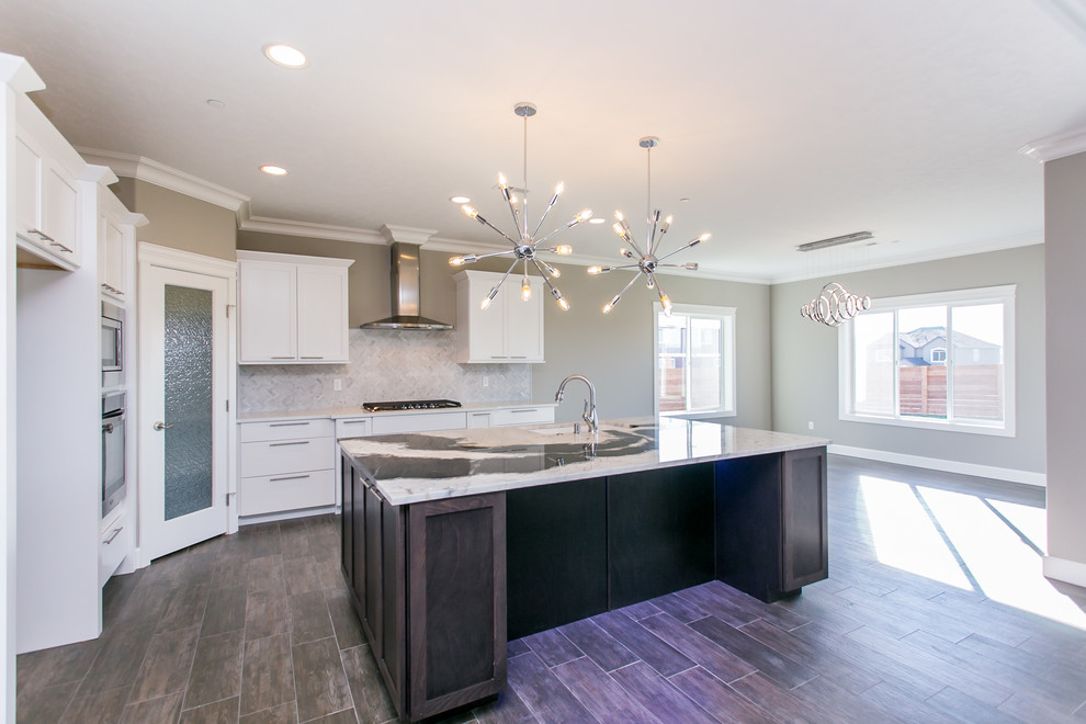 Mid-sized transitional l-shaped dark wood floor open concept kitchen photo in Seattle with an undermount sink, shaker cabinets, white cabinets, granite countertops, gray backsplash, porcelain backsplash, stainless steel appliances and an island