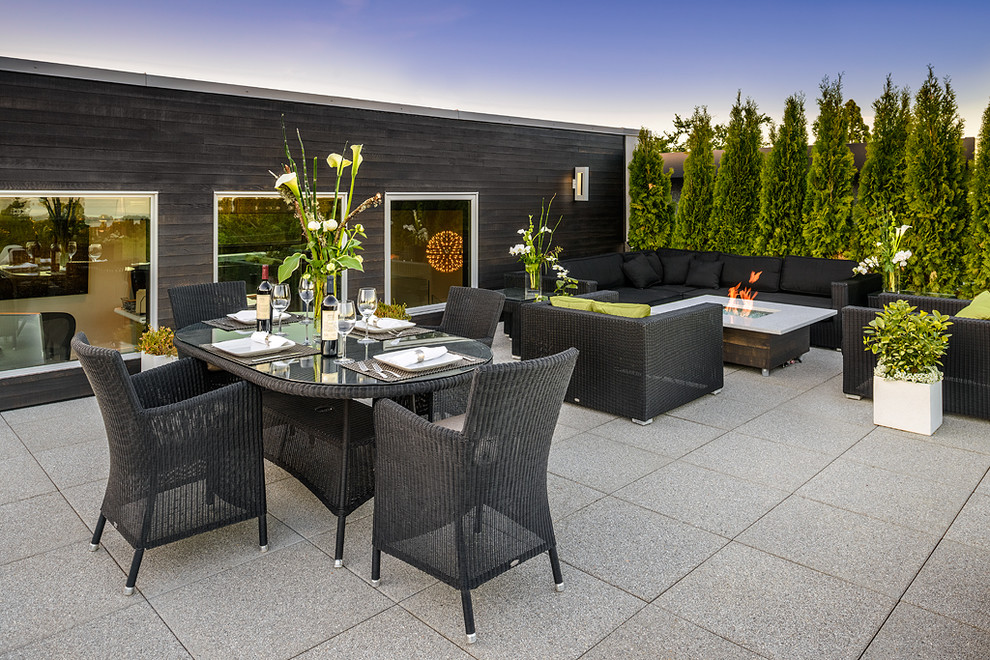 Photo of a contemporary patio in Vancouver with a fire feature.