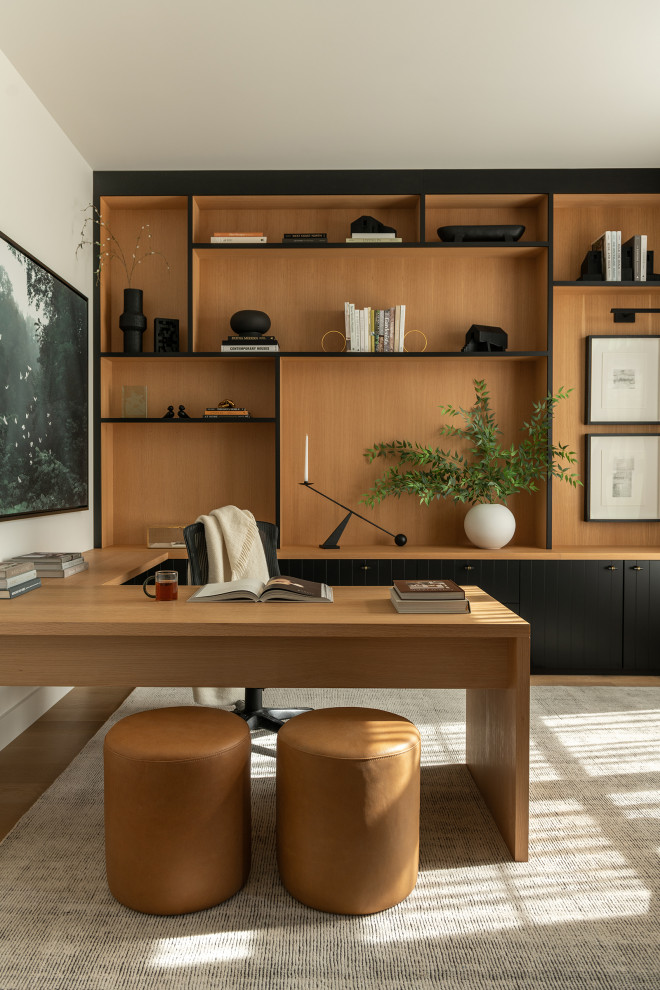 Inspiration for a small contemporary built-in desk light wood floor and brown floor study room remodel in DC Metro with white walls and no fireplace