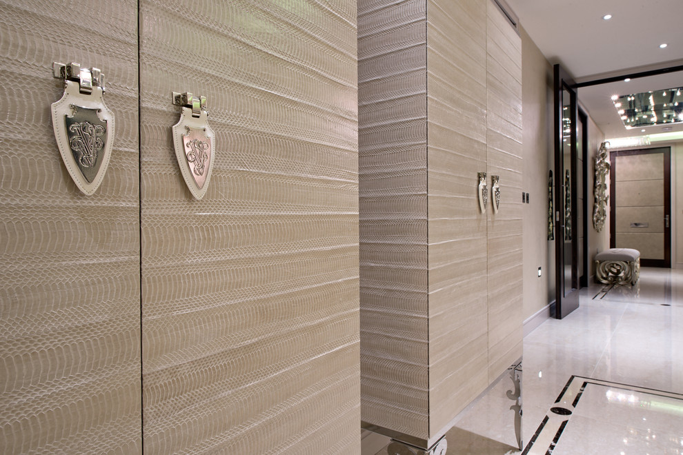 Photo of a mid-sized transitional hallway in London with beige walls and marble floors.