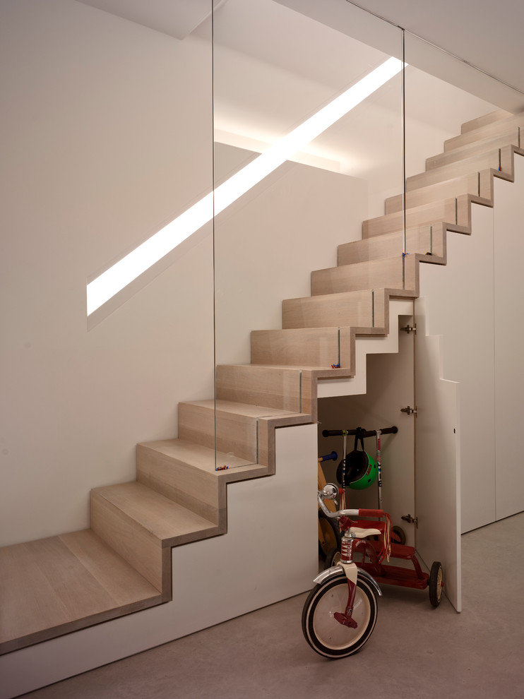 Photo of a contemporary staircase in London with under stair storage.