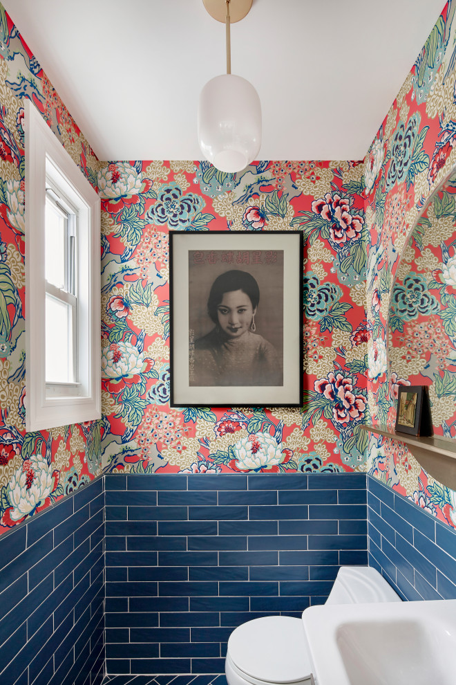 This is an example of a medium sized eclectic cloakroom in New York with beige cabinets, a one-piece toilet, blue tiles, porcelain tiles, red walls, porcelain flooring, a wall-mounted sink, blue floors and a floating vanity unit.