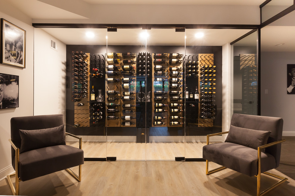 Photo of a large contemporary wine cellar in Chicago with laminate floors, display racks and brown floor.