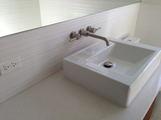 Design ideas for a tropical bathroom in Miami with a vessel sink, solid surface benchtops, white tile and porcelain tile.