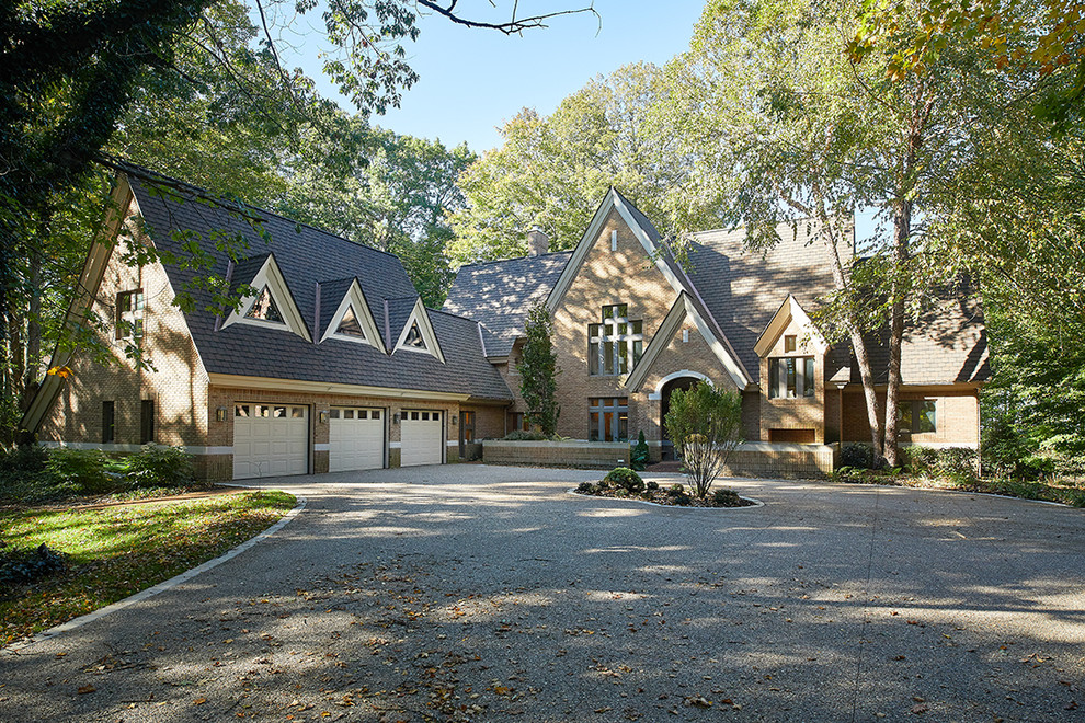 Example of a transitional brown three-story brick house exterior design with a shingle roof and a brown roof