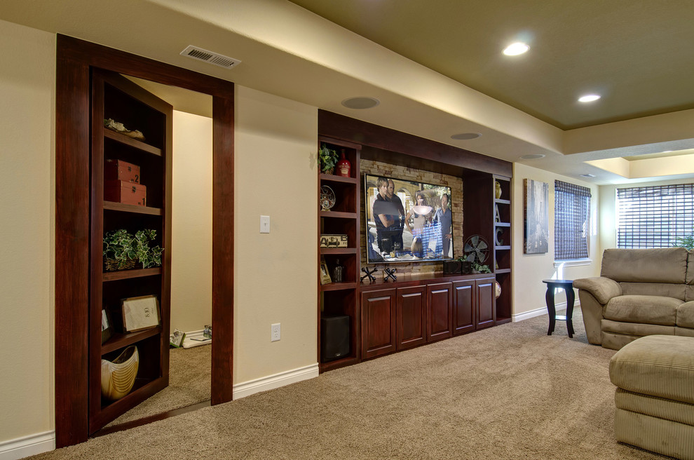Design ideas for a large traditional open concept family room in Denver with a home bar, beige walls, carpet, no fireplace, a wall-mounted tv and beige floor.