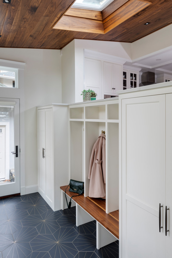 Photo of a mid-sized transitional mudroom in Boston with white walls, a single front door and multi-coloured floor.