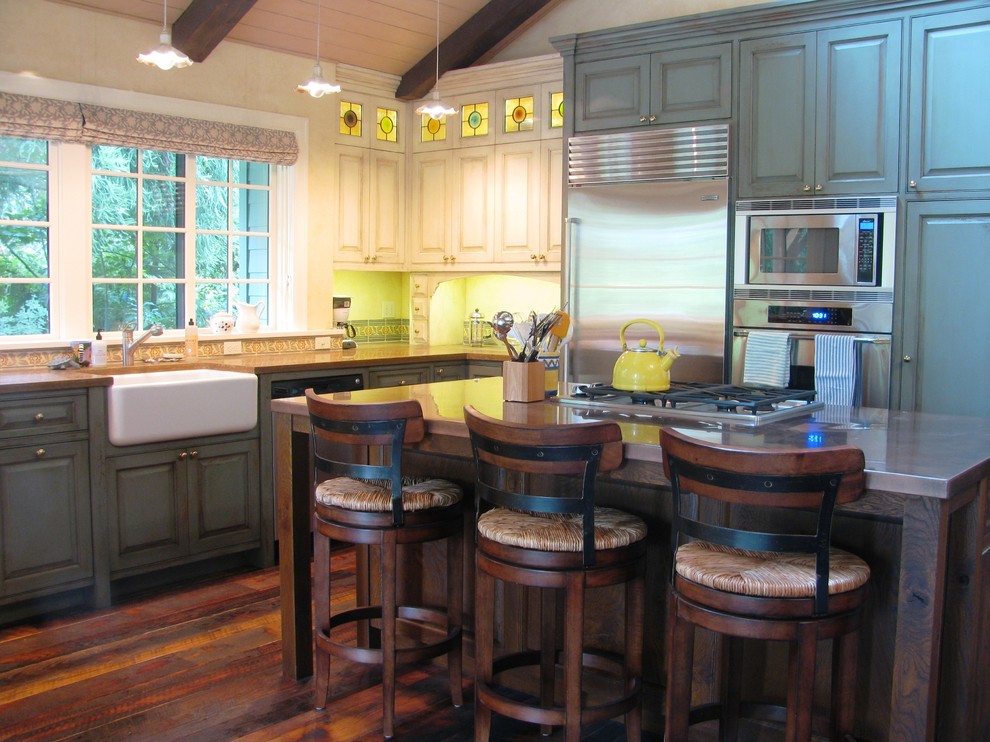 Large traditional l-shaped open plan kitchen in Seattle with an undermount sink, green cabinets, stainless steel appliances, dark hardwood floors, with island, zinc benchtops and brown floor.