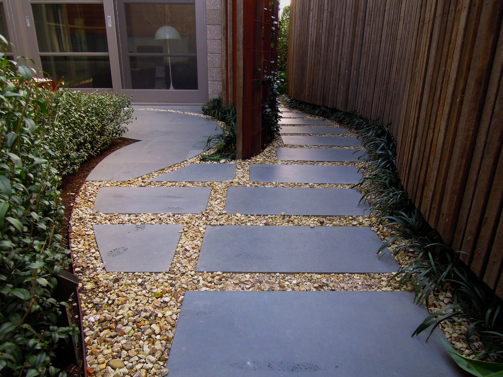 Design ideas for a large contemporary side yard partial sun garden in Melbourne with a garden path and natural stone pavers.