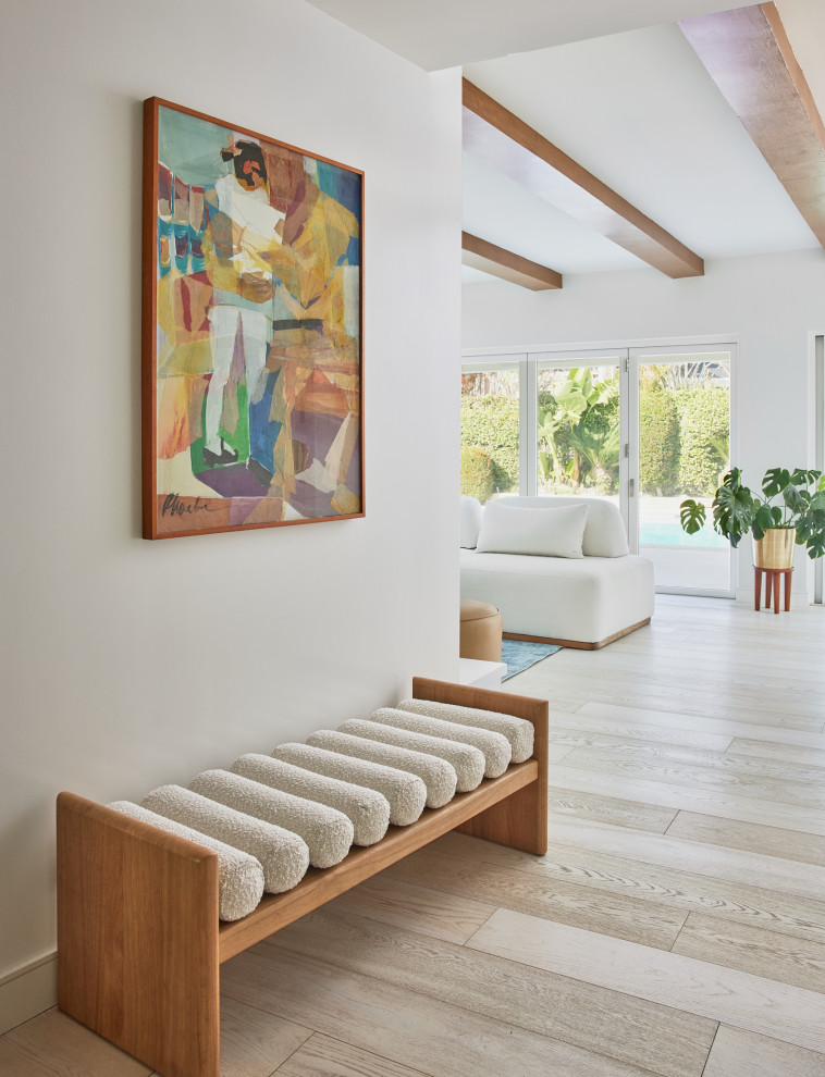 Inspiration for a large midcentury front door in Los Angeles with white walls, light hardwood flooring, a double front door, a medium wood front door and beige floors.