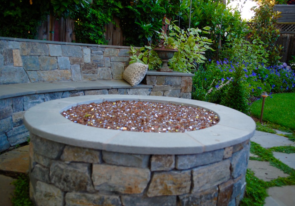This is an example of a small shabby-chic style backyard landscaping in San Francisco with a fire pit.