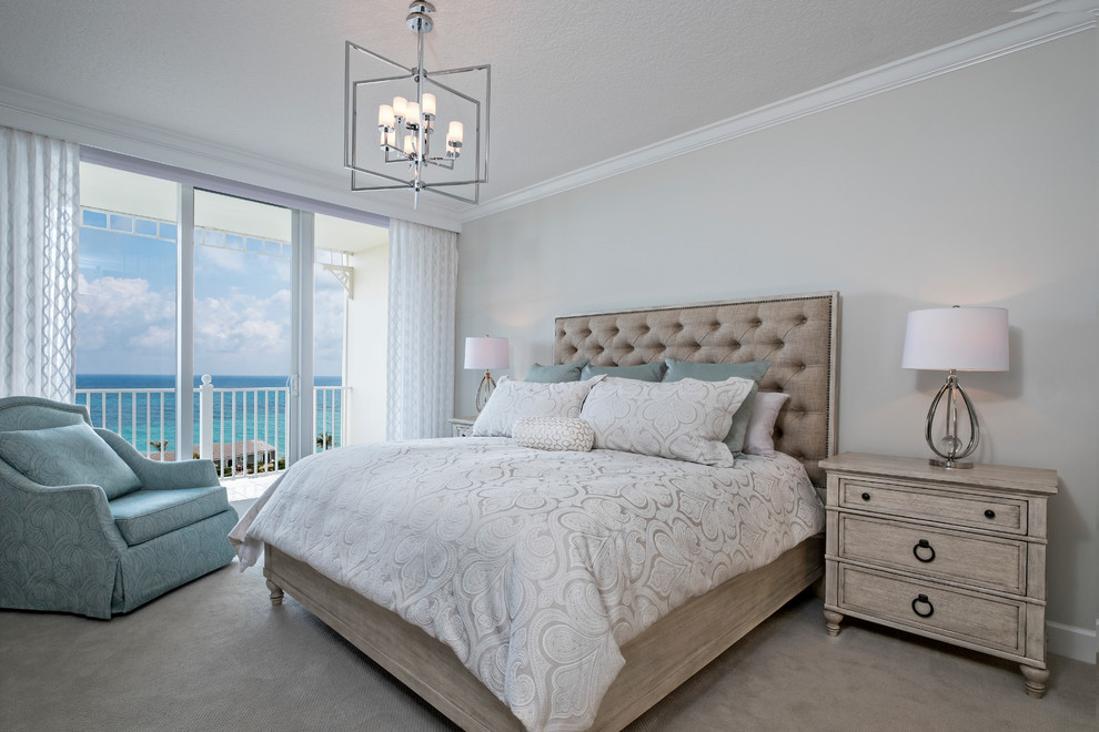 This is an example of a beach style bedroom in Miami with grey walls, carpet and grey floor.