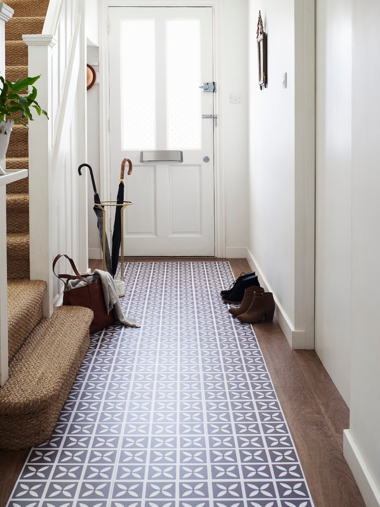 Inspiration for a small contemporary entryway in Manchester with white walls and vinyl floors.