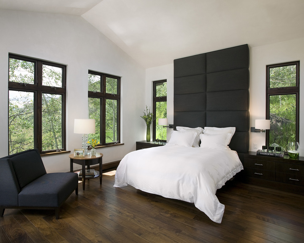 Contemporary bedroom in San Francisco with white walls, dark hardwood floors and brown floor.