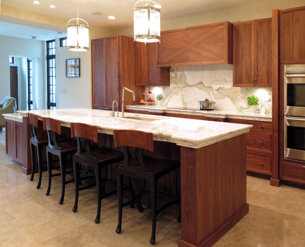 Example of a mid-sized transitional single-wall beige floor eat-in kitchen design in Chicago with an undermount sink, flat-panel cabinets, medium tone wood cabinets, marble countertops, white backsplash, marble backsplash, paneled appliances and an island