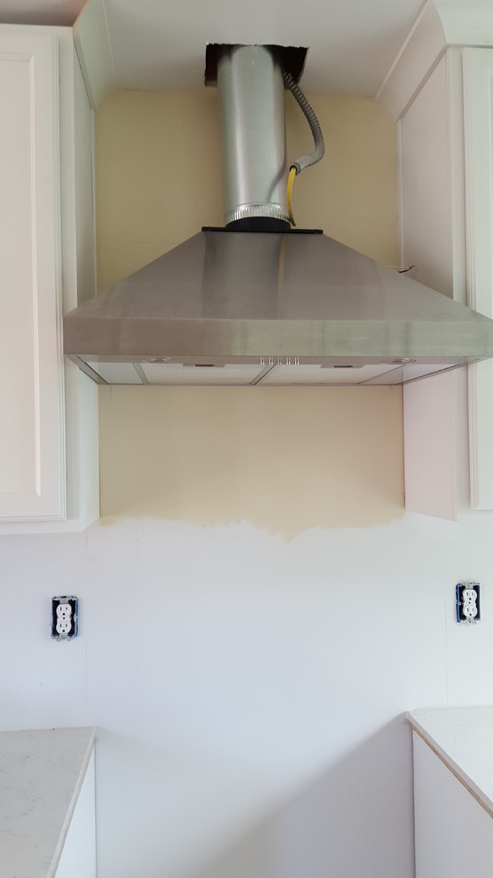 Should backsplash go above the hood too, or just below?