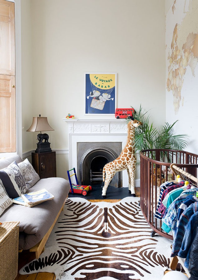 Design ideas for a small eclectic gender-neutral nursery in Edinburgh with yellow walls, light hardwood floors and brown floor.