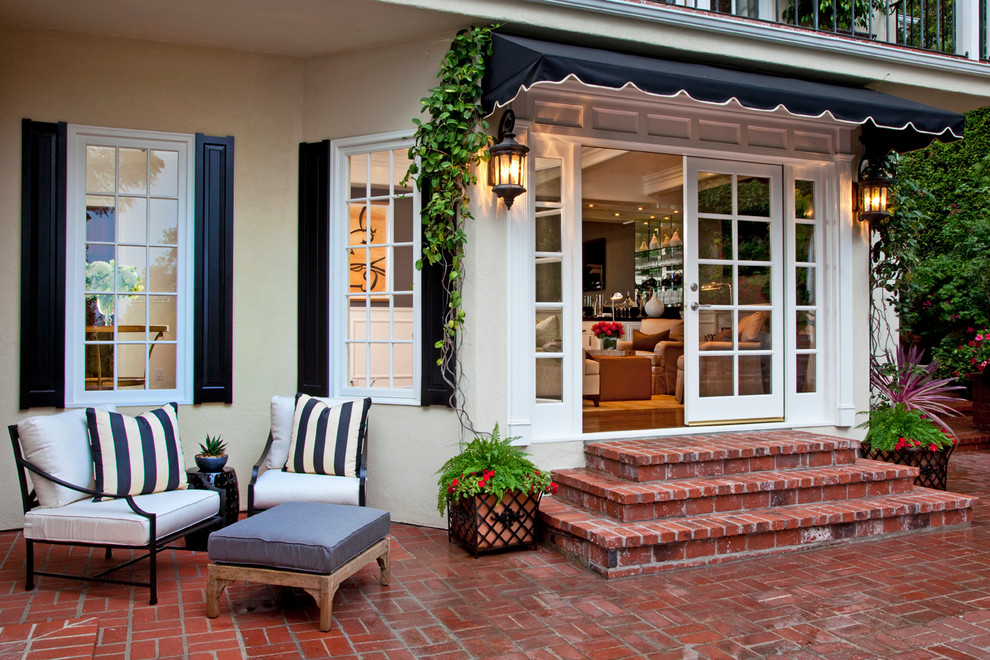 This is an example of a transitional patio in Los Angeles with brick pavers.